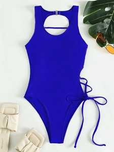 Detail of blue backless swimsuit with side lace-up design and metal buckle accents