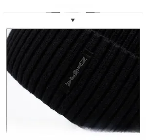 Detailed macro view of the black ribbed knit texture and stylish rectangular NY&JA logo tag