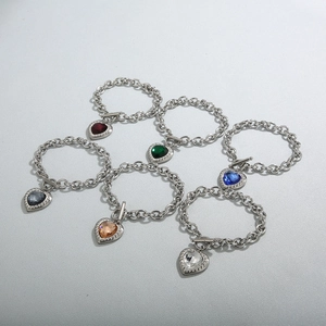 Detail view of heart-shaped gemstone bracelets with toggle clasp and thick chain design