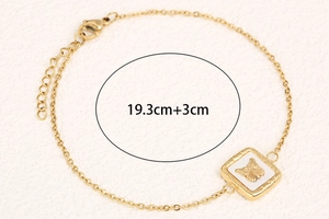 Detail of gold butterfly bracelet with white square inlay and 19.3cm size specification