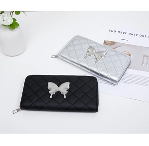 Close-up of quilted long wallets with metallic butterfly decor and Y2K aesthetic design