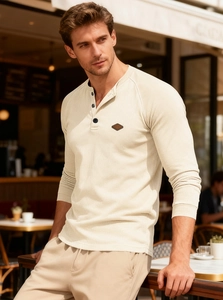Detail of waffle knit fabric and button neckline on a long sleeve Henley shirt