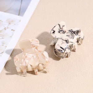 Minimalist marble pattern acetate claw clips in beige and black ink splash styles