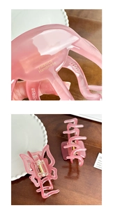 Detail of pink acetate hair claw clip featuring golden France Handmade lettering