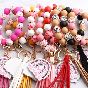 Close-up of leopard and heart pattern beaded wristlet keychain with fringe and mama tag