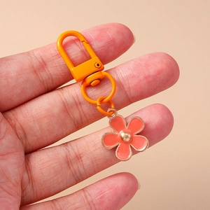 Floral keychain with coral orange flower pendant and gold lobster clasp for bags