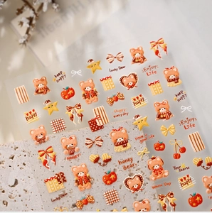 Detailed view of caramel bear nail art stickers with vintage hearts and stars patterns