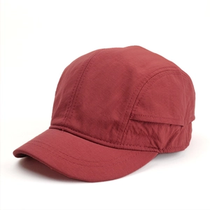 Detailed close-up of burgundy ripstop fabric on a short brim baseball cap