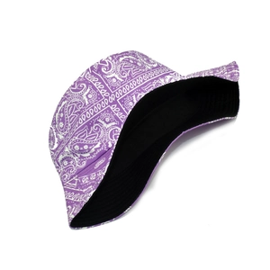 Close-up of purple paisley bucket hat showing the reversible black lining and cotton fabric