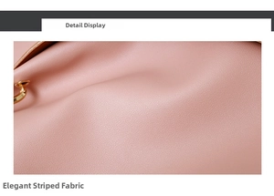 Detail shot of the pink striped fabric texture and gold metal ring on the bucket bag