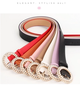 Detail of elegant thin belts with pearl rhinestone buckles in multiple colors for women