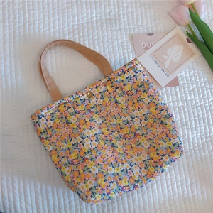 Close-up of floral cotton tote bag with thick fabric and gold metal snap closure detail