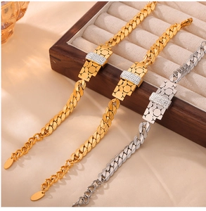 Detailed close-up of Cuban link bracelets with honeycomb charms in a jewelry display box