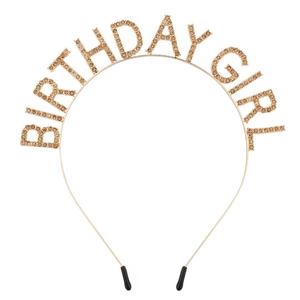 Close-up of golden Birthday Girl headband with sparkling amber rhinestones on white background