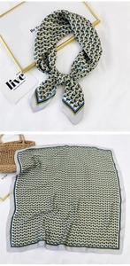 Detail of square silk scarf with geometric triangle patterns used as a necktie