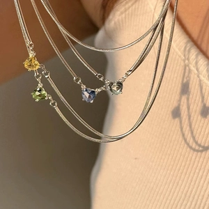 Elegant silver snake chain necklace with colorful heart-shaped zirconia stone pendants