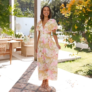 Detail of floral maxi dress with side cut-outs and V-neckline in garden setting