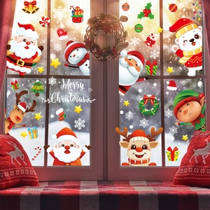 Christmas window stickers featuring Santa, snowman, and reindeer on a snowy glass view