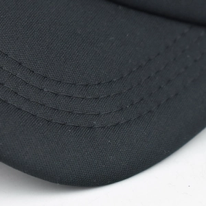 Detail shot of black mesh cap brim featuring precision triple parallel stitching lines