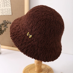 Detail of coffee brown plush bucket hat with a stylish golden bow metal buckle accent