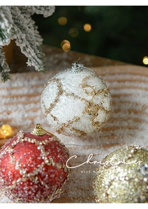 Close-up of 8cm foam Christmas balls with glitter beads and festive lattice texture