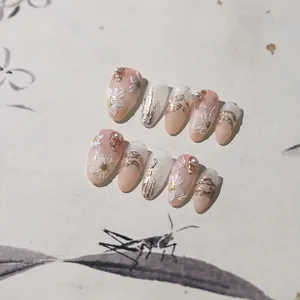 Macro detail of 5D floral embossed press-on nails with gold foil and pearls art