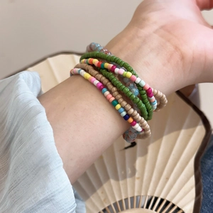 Close-up of bohemian multilayer colorful beaded bracelets set worn on a wrist