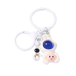 Cute astronaut bunny keychain with space explorer figurine and heart charm on white background