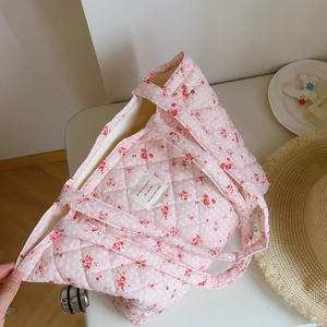Detail of pink floral quilted tote bag featuring diamond stitching and soft cotton fabric