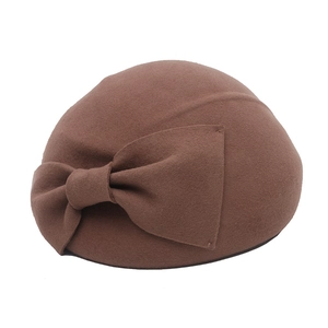 Detail of wool felt beret featuring a vintage dark brown bow and textured wool finish