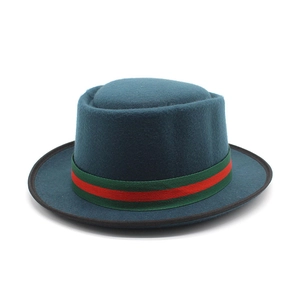 Detail of wool pork pie hat in dark teal with red and green striped ribbon trim