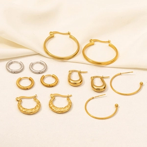 Detailed flat lay of assorted 18K gold hoop earrings with polished and twisted textures