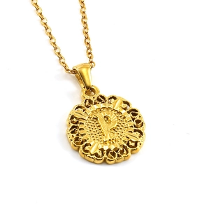 Detailed view of golden round hollow pendant necklace featuring capital letter P charm