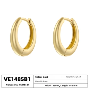Detailed view of polished brass oval hoop earrings with gold finish and dimensions