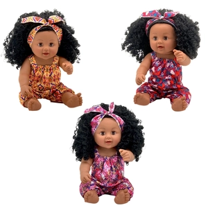 Three African baby dolls with curly hair wearing floral rompers and matching headbands