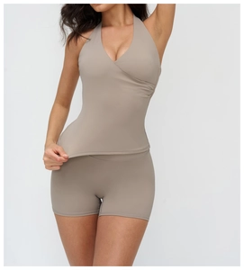 Detail of V-neck halter sports bra and high-waist shorts in mocha brown high-stretch fabric