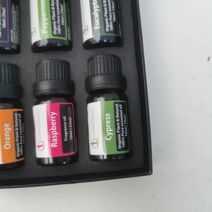 Flat lay of essential oil set with diverse scents in 10ml bottles within foam insert