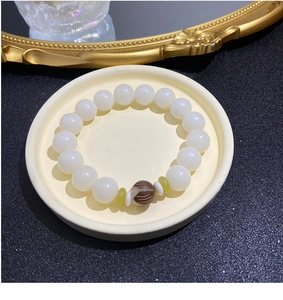 Detailed close-up of white beads with brown stripe accents on a ceramic plate