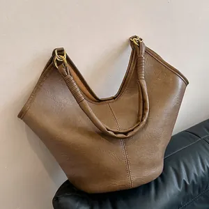 Vintage brown leather tote bag with unique gathered handle and gold ring detail for women