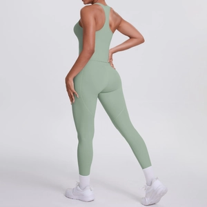 Detail view of high-waisted sage green yoga leggings and racerback sports bra set