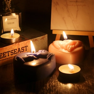 Romantic heart-shaped aromatherapy candles featuring embossed hand-holding design