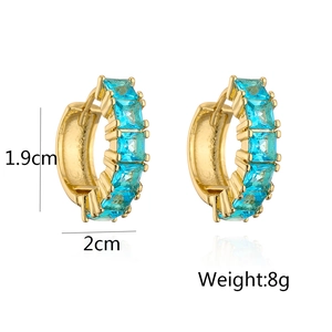 Detail view of gold hoops with blue zircon stones measuring 1.9cm by 2.0cm and weighing 8g