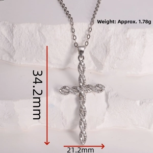 Detail view of silver cross pendant with cubic zirconia inlay and 34.2mm size markings
