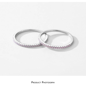 Macro detail of minimalist S925 sterling silver rings with pink pavé set crystals