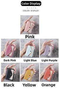 Detail view of multi-colored card holders with gold keychains in seven vibrant candy tones