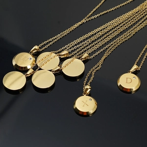 Macro shot of 18K gold plated stainless steel letter pendants with sparkling zircons