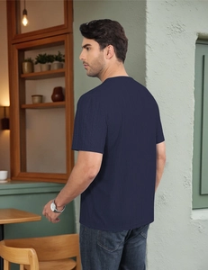 Close-up of deep blue men's t-shirt with vertical ribbed texture and premium knit detail