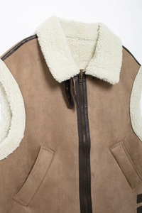 Close-up of brown suede vest featuring white faux shearling collar and metal zipper detail