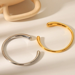 Minimalist gold and silver titanium steel open bangles with droplet ends and mirror finish