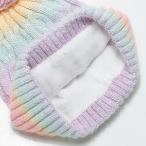 Detail of rainbow gradient knit beanie featuring thick white fleece lining for warmth